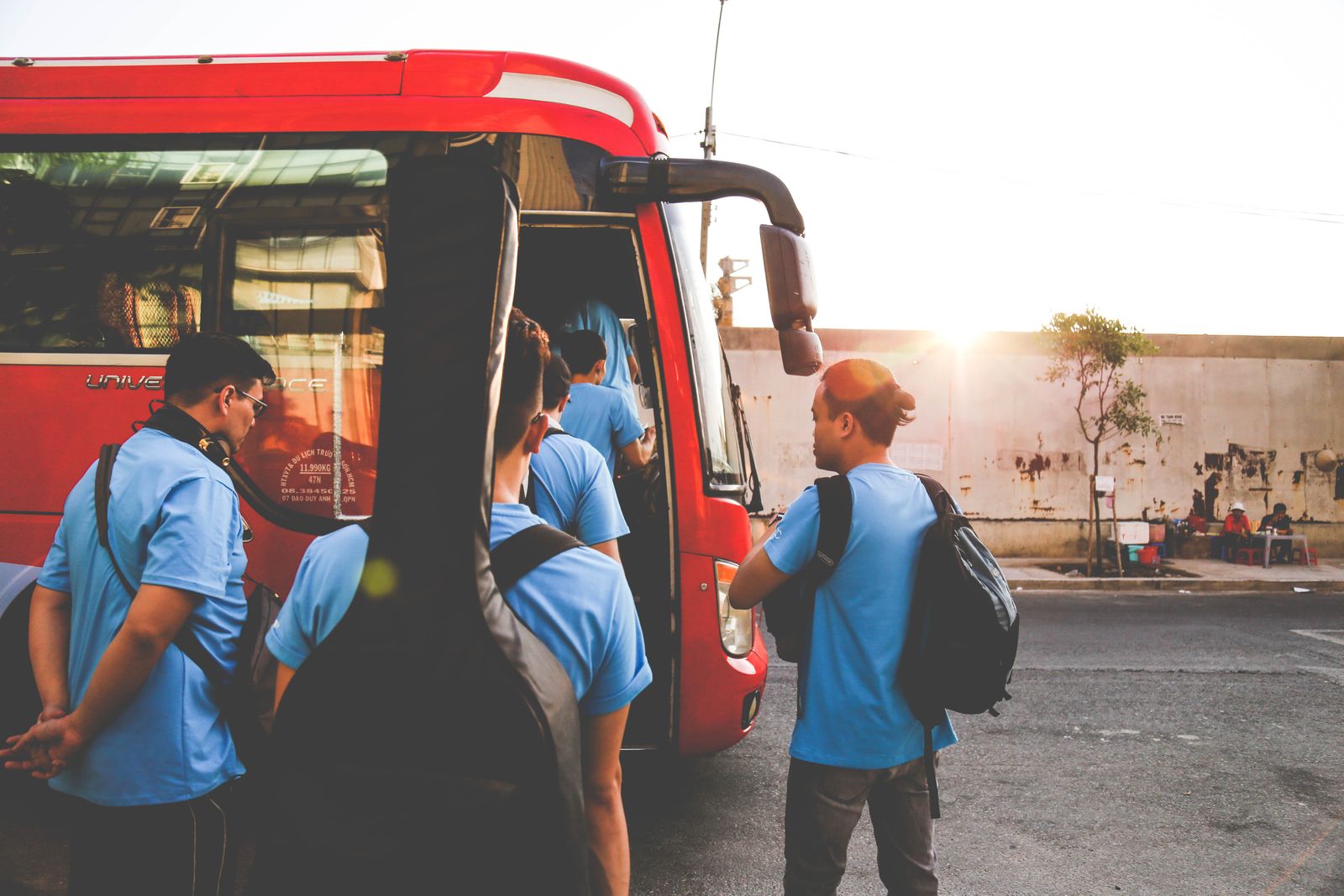 Travellers with luggage at a bus station before Tết